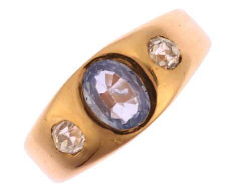 An early 20th century three stone sapphire and diamond gypsy ring, unmarked 18ct gold settings with 0.85ct oval mixed-cut sap