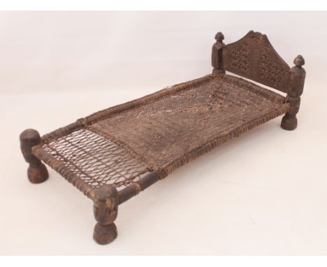 An antique African wood and rattan pygmy bed - (LWH 121 x 58 x 45.5cm)