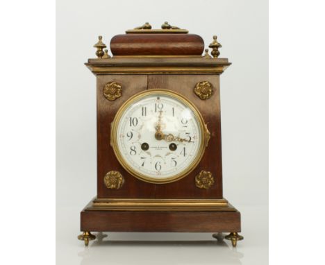 An Edwardian mahogany and brass mantel clock retailed by Hopkins &amp; Hopkins of Dublin - the signed 4&frac12;in white ename