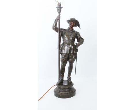 A large bronzed spelter figure of a halberdier converted to a lamp &ndash; early 20th century, with dark and red brown patina