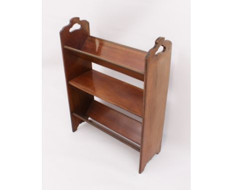 An Edwardian inlaid mahogany book trough &ndash; the shaped end supports with pierced handles and satinwood banding, over two