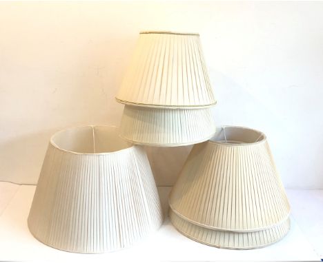 Five pleated ivory silk lamp shades - including a pair (51.5cm diameter), two smaller shades (40.5cm diameter) and one larger