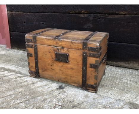 A small antique iron bound pine trunk or chest - with domed lid and side swing handles. (LWH 60 x 34 x 38cm)