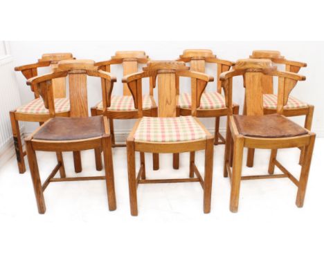A good set of seven Art Deco period/style light oak dining chairs; the central vertical rectangular splat headed with foliate
