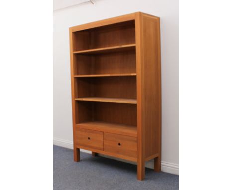 A matching taller modern light-oak bookcase - with four open shelves over two drawers with pierced circular handles, on stile