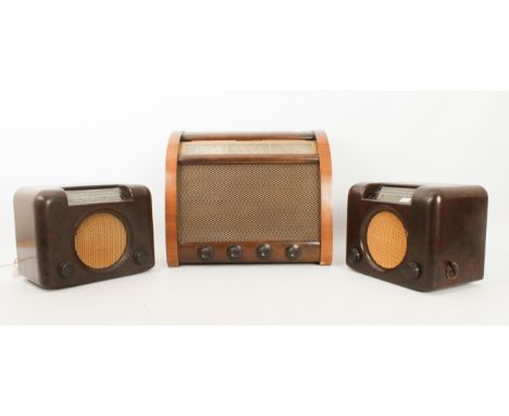 Three vintage 1950s bakelite and walnut radios - comprising two Bush DAC 90A brown bakelite radios with gold speaker grilles;