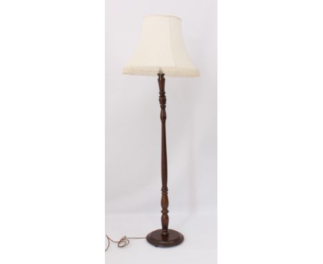 A turned mahogany stained wooden standard lamp - 139cm high, plus shade.