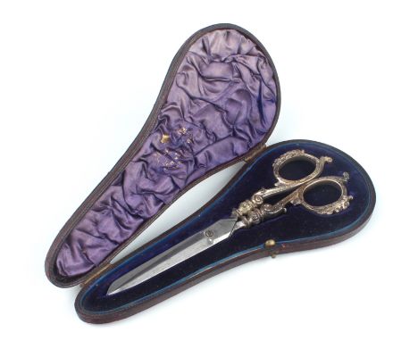 A cased pair of late-Victorian silver dress maker's scissors - William Comyns &amp; Sons, London 1900, with cast silver scrol