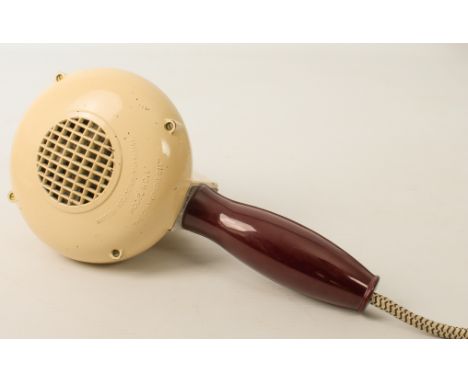A vintage bakelite hairdryer by the Gramophone Co. Ltd. HMV - model HD1, 1930s-40s, maroon bakelite handle and cream-painted 
