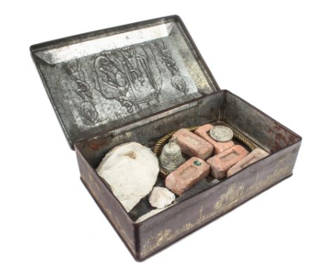 A tin containing interesting old curiosities - including flint tools and an arrowhead; a brass torc style necklace; five mini