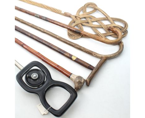 A Mills Munitions Ltd folding shooting stick, first half 20th century - together with four walking canes, one with a novelty 