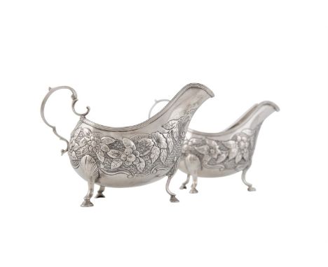 A PAIR OF IRISH SILVER GEORGE III SAUCEBOATS, Dublin 1789, mark of Matthew West, of helmet form, the bodies embossed and chas