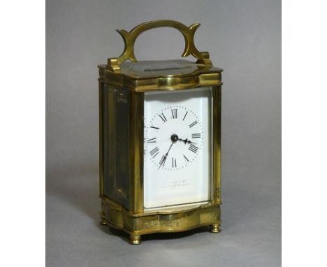 A gilt-brass cased carriage timepiece with black roman numerals to the white enamel dial; 4½” high (hairline crack to dial).