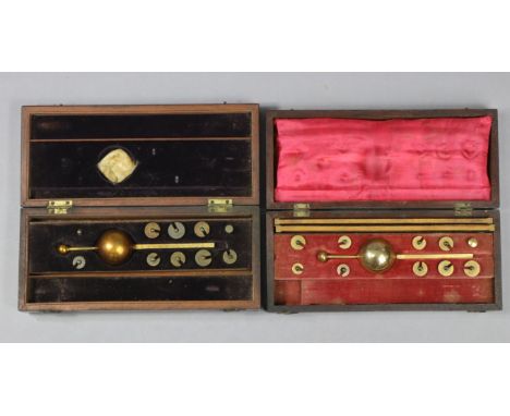 Two vintage Sikes brass hydrometers each in a fitted mahogany case.