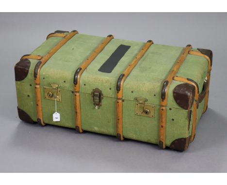 A vintage canvas-covered &amp; leather-bound ribbed travelling trunk with tray &amp; fitted with a pair of brass twin-lever l