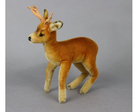 A Steiff reindeer mohair soft toy with button to ear, 13” tall.