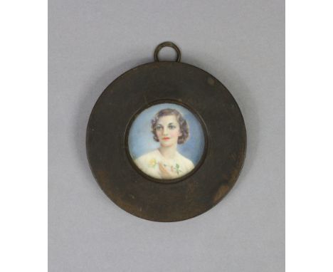 A 19th century English School portrait miniature of a young lady wearing a white blouse, (circular), inscribed to reverse “Ga