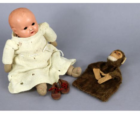 A vintage monkey hand puppet; a Plastex baby doll, 14” tall; &amp; various items of doll’s clothing.