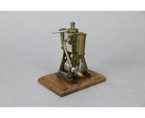 A vintage scratch-built brass &amp; steel small steam engine mounted on wooden plinth, 4¼” high.