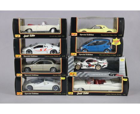 Eight Maisto large scale die-cast model motor cars, each with window box.