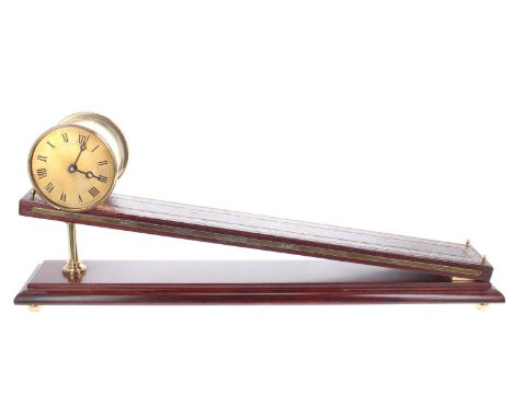Reproduction Dent type inclined gravity clock, the 3.5" brass dial within a drum casing, upon a gilt leather tooled incline s