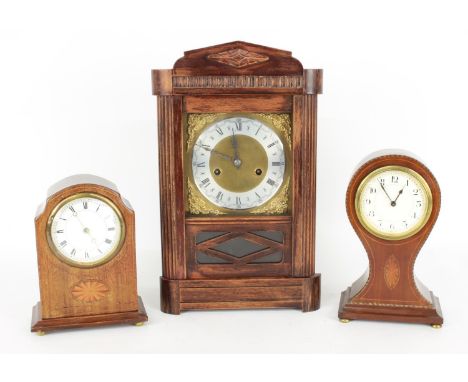 Oak two train mantel clock, the 7.25" square brass dial with silvered chapter ring, within a carved and glazed case, 14.75" h