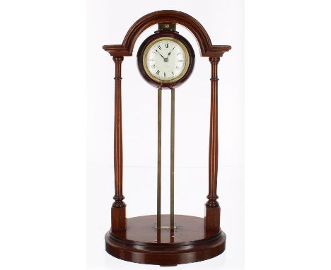 Mahogany cased portico gravity clock, the 2.25" white dial inscribed Pat 23149-10, within a globe casing and fixed to a brass