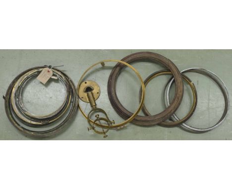 Eight various circular cast clock bezels and some other bezels; also an old brass chronometer gimble 