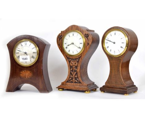 Art Nouveau style small carved oak mantel clock timepiece with platform escapement, within a foliate shaped case, 10" high; a