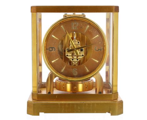 Jaeger Le Coultre Atmos clock, the 4.75" chapter ring enclosing a skeletonised centre, within a brushed brass bevel glazed ca