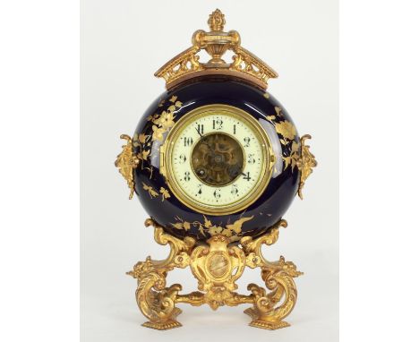 French gilt metal and pottery two train novelty moon shaped mantel clock, the P. Japy &amp; Cie movement with outside countwh