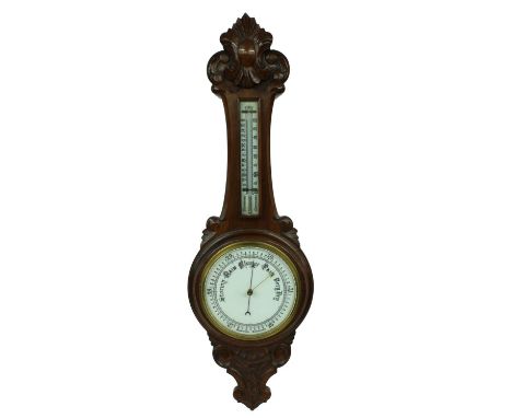 Oak aneroid barometer/thermometer, the 8" white dial within a foliate carved case 