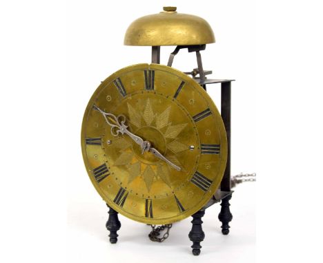 Continental iron and steel single train lantern clock striking on a bell above, the 7.75" circular brass dial with stylised e