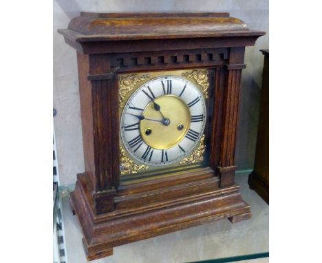 A German striking oak cased mantle clock.