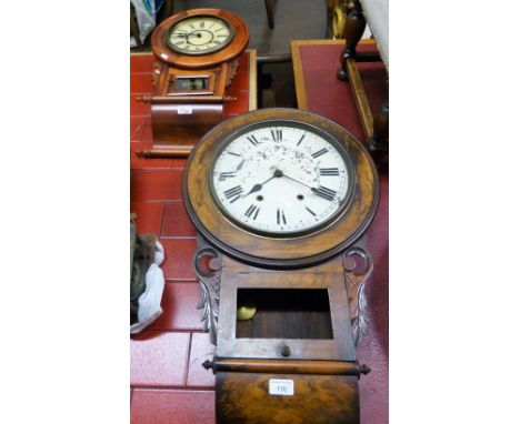 A circular drop dial wall clock, the white enamel dial with Roman numerals, pendulum together with another smaller example. (