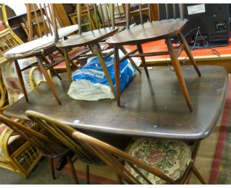 An Ercol dark elm dining suite comprising refectory style table 182cm long, set of six stick back chairs and panelled Welsh d