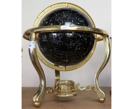 A celestial table globe mounted in a brass frame.