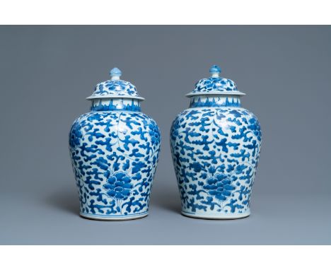 Full title: A pair of Chinese blue and white 'peony scroll' vases and covers, KangxiDescription:H.: 38,5 cmThe absence of a c