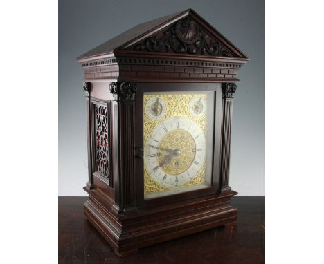 An Edwardian mahogany chiming bracket clock, clock 22.5in., overall 34in. An Edwardian mahogany chiming bracket clock, in arc
