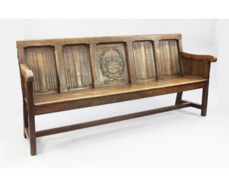 An Edwardian carved oak bench seat, formerly from Christ's Hospital, Sussex, W.7ft An Edwardian carved oak bench seat, former