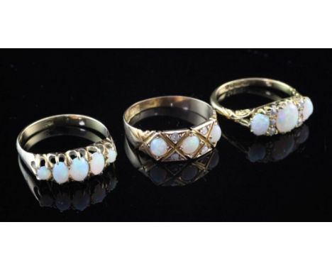 Three early 20th century gold and white opal rings, various sizes. Three early 20th century gold and white opal rings, to inc