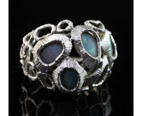 A textured 18ct white gold and five stone white opal set free form ring, size M. A textured 18ct white gold and five stone wh