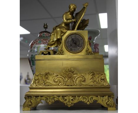 A 19th century French Empire style ormolu mantel clock 20in. A 19th century French Empire style ormolu mantel clock surmounte