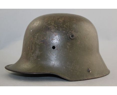 A German WWI M16 helmet, A German WWI M16 helmet, with green paint, no liner or chin strap