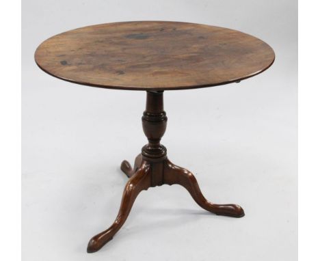 A George II mahogany tilt-top table, D 2ft 11.25in A George II mahogany tilt-top table, the bevelled circular top on baluster