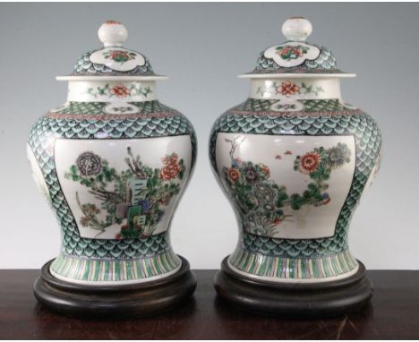 A pair of Chinese famille verte baluster vases and covers, late 19th century, 29.5cm, later drilled for lamp fittings, wood s