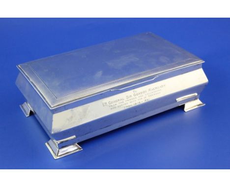 A George V engine turned silver cigarette box with later inscription relating to Lt.General Sir Gordon Macready, gross 41 oz.