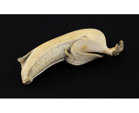 A Japanese ivory model of a partially peeled banana, early 20th century, 4.5cm, unsigned, re-glued section to tip A Japanese 