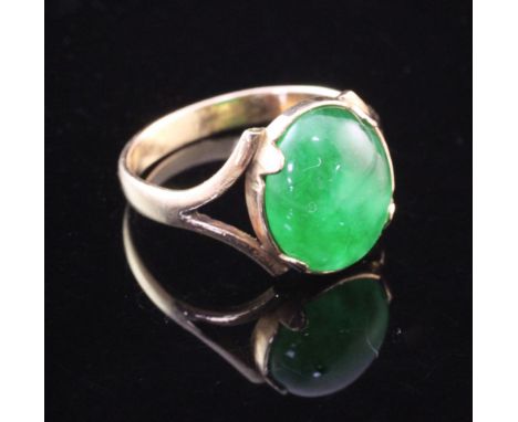 A gold and cabochon jade set ring, size N. A gold and cabochon jade set ring, size N.