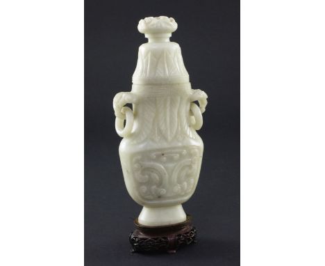 A Chinese greyish white bowenite jade archaistic vase and cover, 20th century, 17cm, wood stand A Chinese greyish white bowen